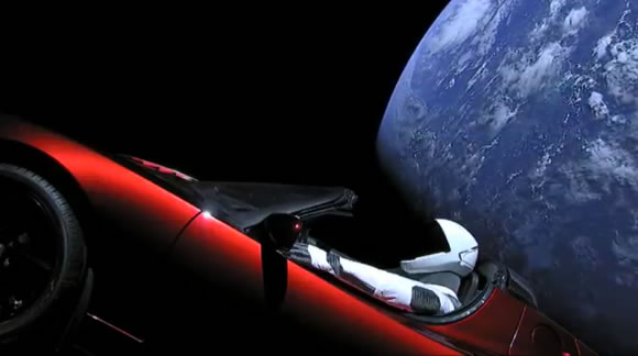 Starman in the red Tesla Roadster with Earth behind, photographed during the 2018 SpaceX launch